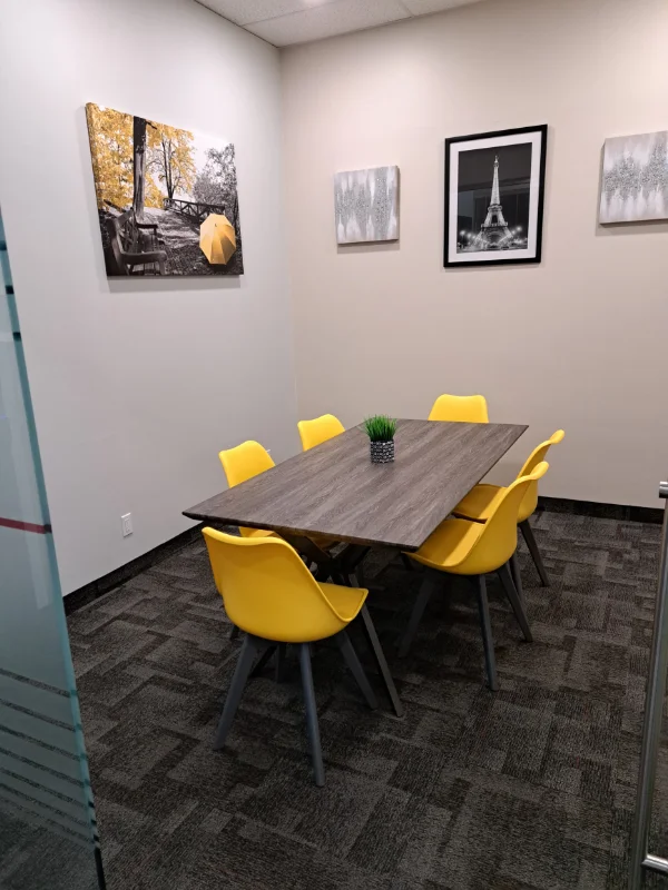 Meeting room with yellow chairs and artwork
