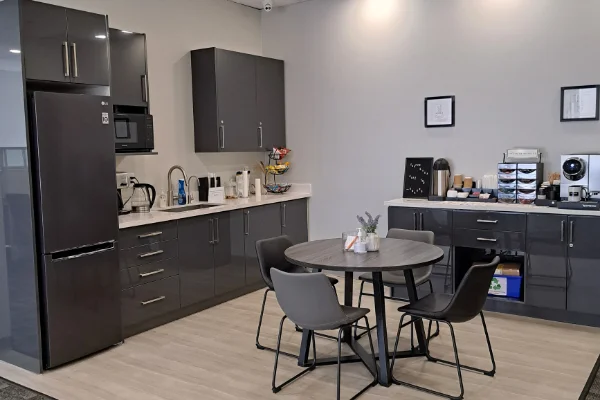 kitchenette coffee station Modern kitchen with dining table and appliances
